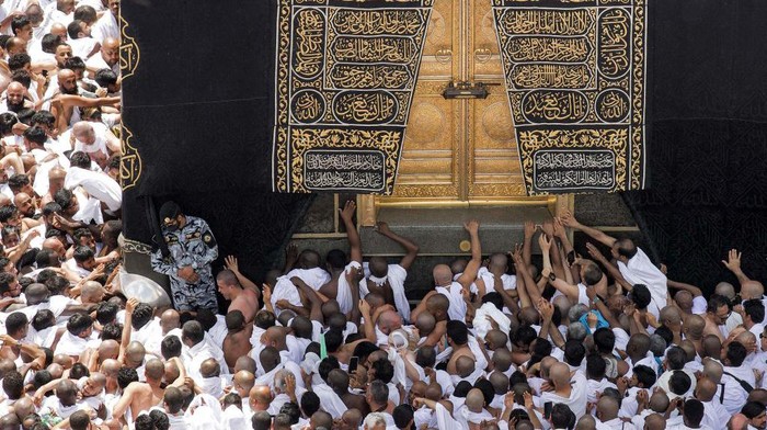 Muslim worshippers reach for a blessing to touch the Kaaba, Islams holiest shrine, at the Grand Mosque in the holy city of Mecca during the second Friday prayers in the holy month of Ramadan on March 31, 2023. (Photo by Abdel Ghani BASHIR / AFP) (Photo by ABDEL GHANI BASHIR/AFP via Getty Images)