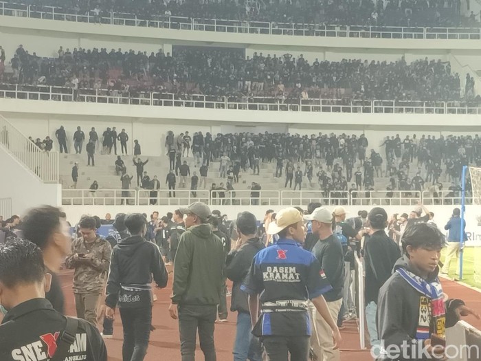 Suasana keributan antar-suporter di tengah laga PSIS Semarang melawan PSS Sleman di Stadion Jatidiri Semarang, Minggu (2/4/2023) malam.