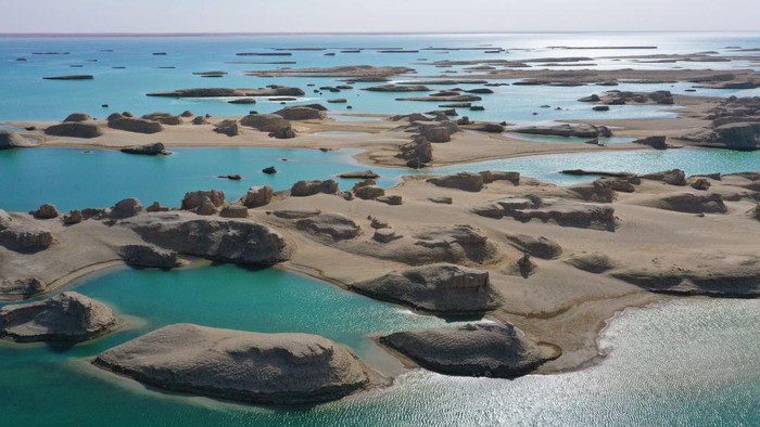 HAIXI, CHINA - MARCH 30: Aerial view of Yardang rocks in the Wusute Yadan Geological Park in Qaidam Basin on March 30, 2023 in Haixi Mongolian and Tibetan Autonomous Prefecture, Qinghai Province of China. Lying in the Qaidam Basin, the Wusute Yadan Geological Park is home to a unique landscape which consists of wind-eroded rocks known as yardangs. (Photo by Ma Mingyan/China News Service/VCG via Getty Images)