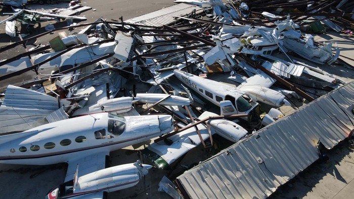 The wing of a damaged plane is seen in a collapsed hangar at Robinson Municipal Airport, two days after a tornado hit Palestine, Illinois, U.S., April 2, 2023.  REUTERS/Jon Cherry