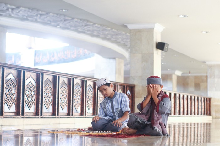 Muslim boys salat in the mosque