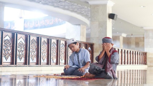 Muslim boys salat in the mosque