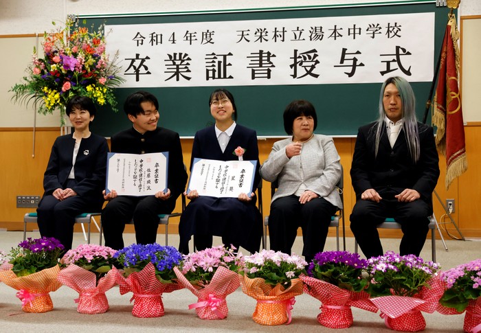 Eita Sato, 15, and Aoi Hoshi, 15, who are the only two students at Yumoto Junior High School, attend a Japanese traditional calligraphy class to write a message that will be engraved into the school's closing memorial stone, a few days before their graduation and the institution's closing ceremony, in Ten-ei Village, Fukushima Prefecture, Japan, March 9, 2023. Eita and Aoi, who have been together since three, are the last two graduates of Yumoto Junior High, a public school established in 1947 that in its prosperous years sent out more than 50 graduates, but with only a few enrolments expected in the coming years, the village decided to close the school for good. 