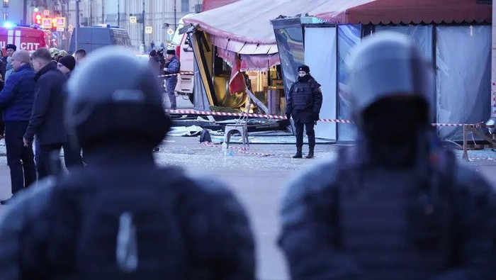 Russian police officers are seen at the site of an explosion at a cafe in St. Petersburg, Russia, Sunday, April 2, 2023. An explosion tore through a cafe in the Russian city of St. Petersburg on Sunday, and preliminary reports suggested a prominent military blogger was killed and more than a dozen people were injured. (AP Photo)