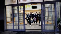 Eita, Aoi dan keluarga mereka meninggalkan sekolah setelah upacara kelulusan terakhir dan upacara penutupan sekolah pada 13 Maret 2023 lalu .Foto: REUTERS/ISSEI KATO