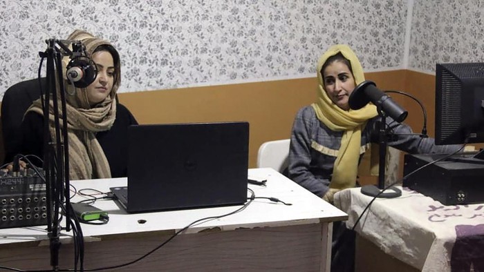 Najia Sorosh head of Sadai Banowan a women-run radio station, left, speaks into a microphone in the broadcasting studio in Badakhshan province, north-eastern of Afghanistan, Wednesday, Jan. 4, 2023. A women-run radio station in Afghanistan's northeast has been shut down for playing music during the holy month of Ramadan, a Taliban official said Saturday. (Sadai Banowan via AP)