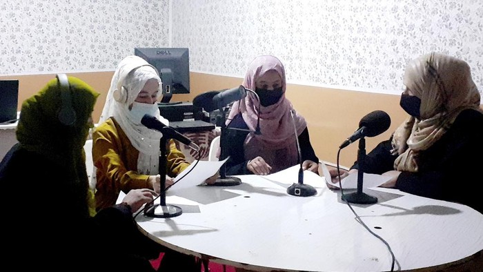 Najia Sorosh head of Sadai Banowan a women-run radio station, left, speaks into a microphone in the broadcasting studio in Badakhshan province, north-eastern of Afghanistan, Wednesday, Jan. 4, 2023. A women-run radio station in Afghanistan's northeast has been shut down for playing music during the holy month of Ramadan, a Taliban official said Saturday. (Sadai Banowan via AP)