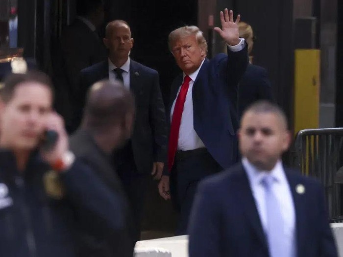 Former President Donald Trump waves to supporters upon arriving at Trump Tower, Monday, April 3, 2023, in New York. Trump arrived in New York on Monday for his expected booking and arraignment the following day on charges arising from hush money payments during his 2016 campaign. (AP Photo/Yuki Iwamura)
