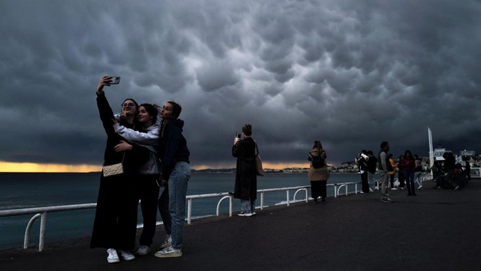 People take pictures of mammatus clouds on the 