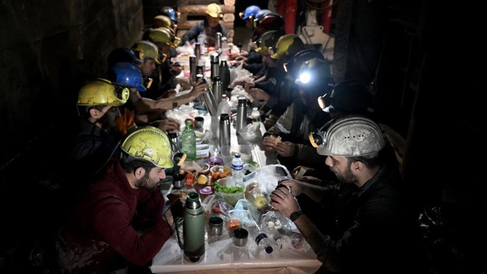 MANISA, TURKIYE - MARCH 27: Miners pray before iftar (breaking the fast) time at mine site, one of Turkiye's major lignite coal production centers, during the holy month of Ramadan in Soma district of Manisa, Turkiye on March 25, 2023. About 500 miners in the mining company returned to the mine site on after participating in search and rescue operation following 7.7 and 7.6 magnitude earthquakes hit multiple provinces of Turkiye occurred on Feb. 06. The miners, who work hundreds of meters below the site according to their shifts, also fulfill the requirements of the holy month of Ramadan despite their difficult professions. According to their working hours, they spend their iftar and sahur (pre-dawn) together. (Photo by Mahmut Serdar Alakus/Anadolu Agency via Getty Images)