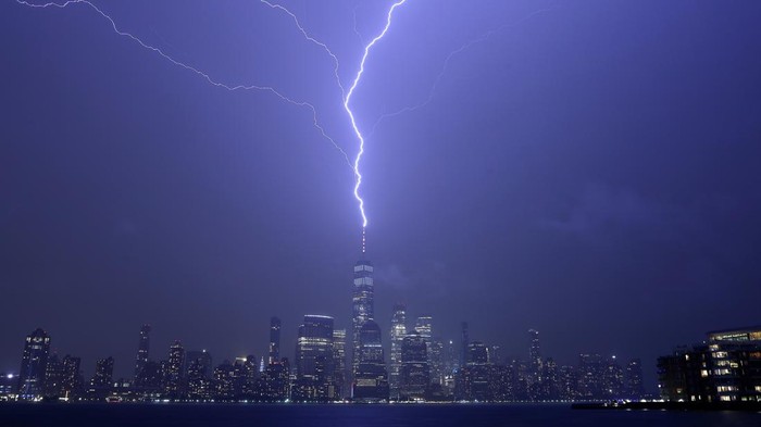 HOBOKEN, NJ - APRIL 1: Lightning bolts strike One World Trade Center in New York City as it fans out over the Hudson River and Jersey City, New Jersey during a thunderstorm on April 1, 2023, as seen from Hoboken, New Jersey.  (Photo by Gary Hershorn/Getty Images)