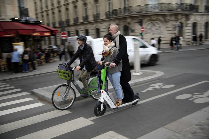 A man parks a scooter in Paris, Friday, march 31, 2023. Romantically zipping two-to-a-scooter, wind in the hair, past the Eiffel Tower and other iconic sights could soon become a thing of the past if Parisians vote Sunday to do away with the 15,000 opinion-dividing micro-machines. (AP Photo/Christophe Ena)