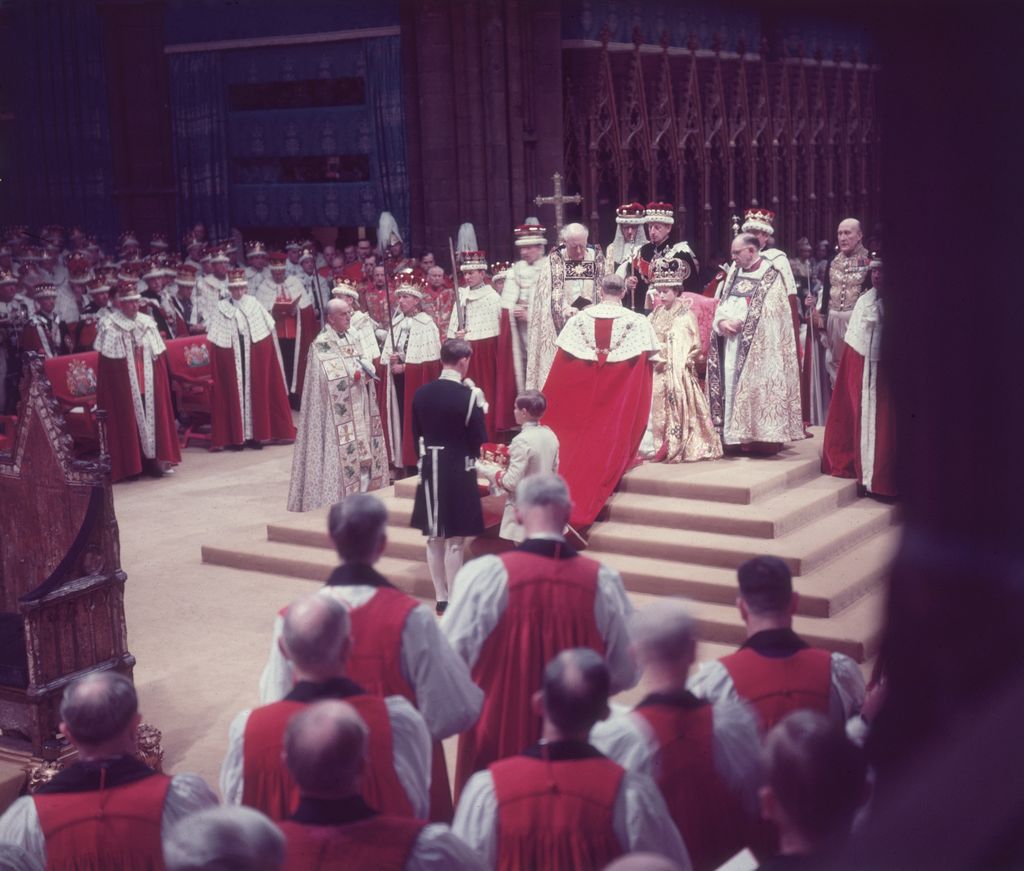 The Duke of Edinburgh pays homage to his wife, the newly crowned Queen Elizabeth II, during her coronation ceremony, Westminster Abbey, London, England, June 2, 1953. (Photo by Hulton Archive/Getty Images)