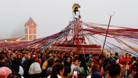 Tampak patung Yesus Nazareno diarak dan ditarik dengan pita di jalanan.  