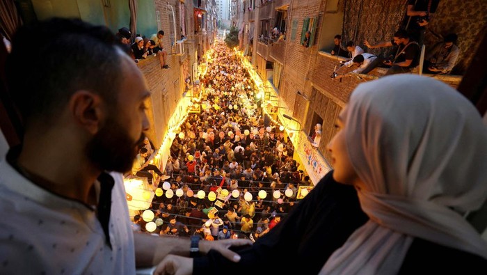 Momen Kebersamaan Buka Puasa Bersama di Kairo Residents of Ezbet Hamada in Cairo's Mataria district gather to eat Iftar, the meal to end their fast at sunset, during the holy fasting month of Ramadan in Cairo, Egypt April 6, 2023. REUTERS/Mohamed Abd El Ghany