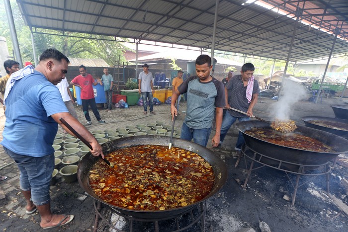 Warga menyiapkan menu kuliner tradisional kuah beulangong (kari daging sapi) untuk dibagikan kepada penduduk desa pada peringatan tradisi kenduri Nuzulul Quran di Pango Raya, Banda Aceh, Aceh, Sabtu (8/4/2023). Menu kuliner tradisional kuah beulangong yang dimasak secara gotong royong itu selain untuk dinikmati saat buka puasa bersama padda peringatan Nuzulul Quran 1444 H juga dibagi-bagikan kepada seluruh warga desa, fakir, miskin, dan anak yatim. ANTARA / Irwansyah Putra/hp..
