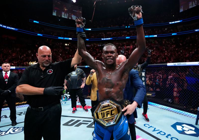 MIAMI, FLORIDA - APRIL 08: Israel Adesanya of Nigeria reacts after knocking out Alex Pereira of Brazil in the UFC middleweight championship fight during the UFC 287 event at Kaseya Center on April 08, 2023 in Miami, Florida. (Photo by Jeff Bottari/Zuffa LLC via Getty Images)