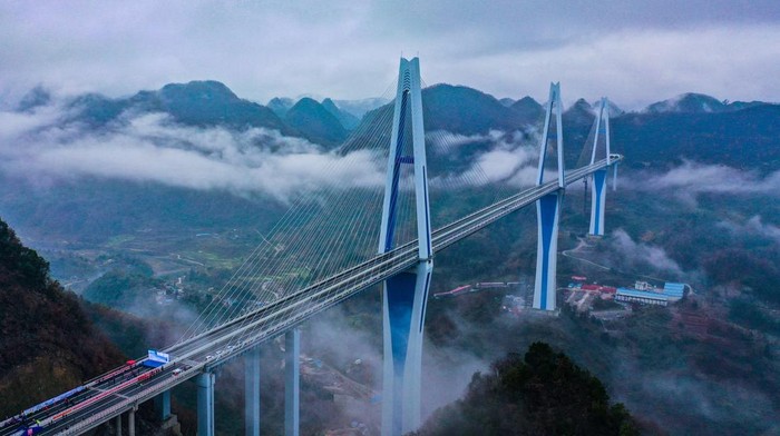 PINGTANG, CHINA - DECEMBER 30, 2019 - A view of the Pingtang Bridge on its opening day in Pingtang county in southwest Chinas Guizhou province Monday, Dec. 30, 2019. The cable-stayed bridge has three concrete pylons, the tallest of which is 332-meter-tall, a world record.- PHOTOGRAPH BY Feature China / Future Publishing (Photo credit should read Feature China/Future Publishing via Getty Images)