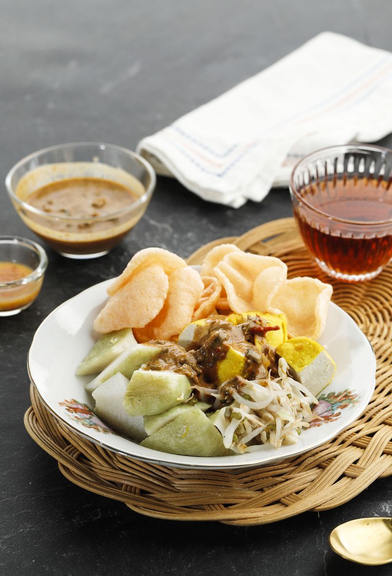 Ketoprak or Kupat Tahu, Compressed Rice Cake or Lontong Served with Tofu, Boiled Bean Sprout, Karupuk, and Peanut Sauce. Indonesian Street Food for Breakfast