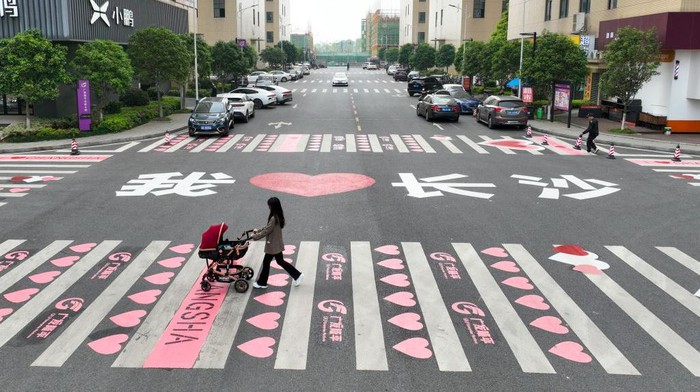 CHANGSHA, CHINA - APRIL 12: Aerial view of a zebra crossing decorated with pink heart-shaped patterns and Chinese characters reading 'I love Changsha' on April 12, 2023 in Changsha, Hunan Province of China. (Photo by Yang Huafeng/China News Service/VCG via Getty Images)