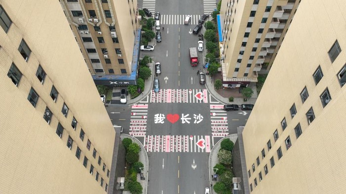 CHANGSHA, CHINA - APRIL 12: Aerial view of a zebra crossing decorated with pink heart-shaped patterns and Chinese characters reading 'I love Changsha' on April 12, 2023 in Changsha, Hunan Province of China. (Photo by Yang Huafeng/China News Service/VCG via Getty Images)