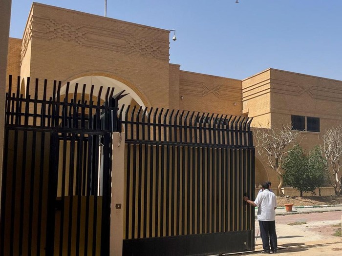 People stand outside the Iranian embassy in Riyadh, Saudi Arabia, April 12, 2023. REUTERS/Aziz El Yaakoubi