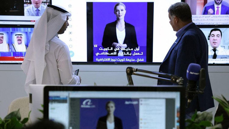 Media Kuwait Perkenalkan Presenter Berita dengan Teknologi AI TOPSHOT - A journalist watches an introductory video by the artificial intelligence anchor Fedha on the twitter account of Kuwait News service, in Kuwait City on April 9, 2023. (Photo by YASSER AL-ZAYYAT / AFP) (Photo by YASSER AL-ZAYYAT/AFP via Getty Images)