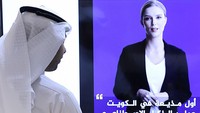 TOPSHOT - A journalist watches an introductory video by the artificial intelligence anchor Fedha on the twitter account of Kuwait News service, in Kuwait City on April 9, 2023. (Photo by YASSER AL-ZAYYAT / AFP) (Photo by YASSER AL-ZAYYAT/AFP via Getty Images)