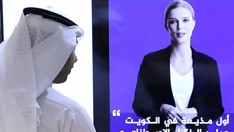 TOPSHOT - A journalist watches an introductory video by the artificial intelligence anchor Fedha on the twitter account of Kuwait News service, in Kuwait City on April 9, 2023. (Photo by YASSER AL-ZAYYAT / AFP) (Photo by YASSER AL-ZAYYAT/AFP via Getty Images)