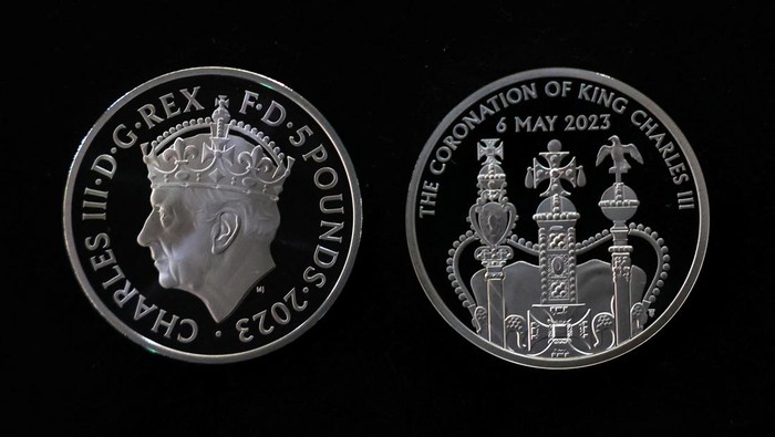 Factory worker, Jason, checks a commemorative 50 pence coin after pressing, in Llantrisant, Britain, April 12, 2023. The coin is unveiled by The Royal Mint to celebrate the upcoming coronation of King Charles III. REUTERS/Molly Darlington
