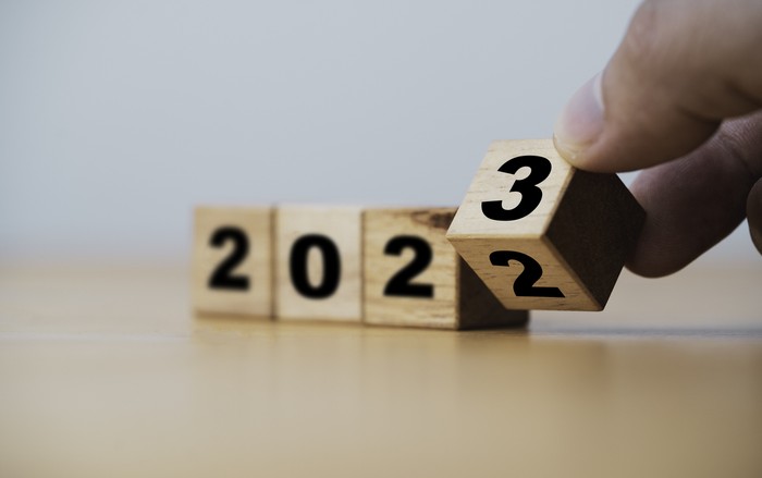 Wooden block cube flipping between 2022 to 2023 for change and preparation merry Christmas and happy new year.
