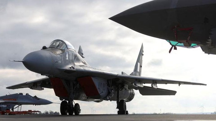 MiG-29 and F-35 (R) aircrafts are parked on a tarmac during a NATO media event at an airbase in Malbork, Poland, March 21, 2023. REUTERS/Lukasz Glowala