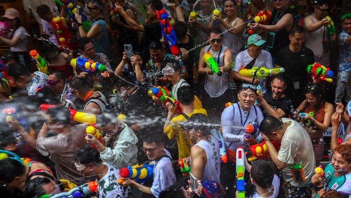 Locals and tourists play with water as they celebrate the Songkran holiday which marks the Thai New Year in Bangkok, Thailand, April 13, 2023. REUTERS/Athit Perawongmetha