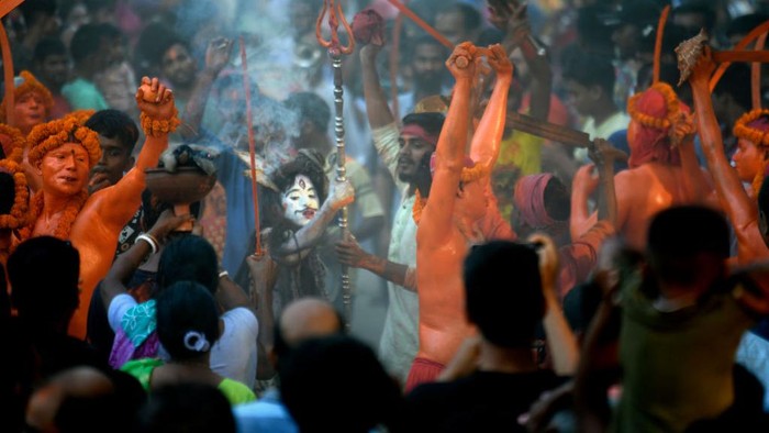 Hindu devotees rest during a festival called Lal Kach (Red Glass) on the last day of the Bangla month in Munshigonj, Dhaka, Bangladesh on Thursday, April 13, 2023. The Lal Kach festival has been well-known in the local community for over a hundred years. The Hindu youth and men paint themselves with color and attend a procession holding swords as they show power against evil and welcome the Bengali New Year.  (Photo by Syed Mahamudur Rahman/NurPhoto via Getty Images)