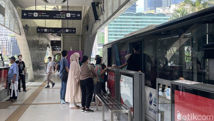 Suasana penumpang hendak menaiki bus transjakarta di Halte Bundaran HI, Sabtu (15/4/2023).