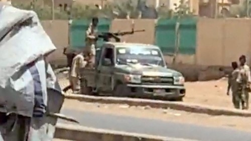 A military vehicle and soldiers said to be from the Sudanese armed forces are seen on a street in Khartoum, Sudan, April 15, 2023 in this picture screen grab obtained from a social media video. Bakri Jad/via REUTERS  THIS IMAGE HAS BEEN SUPPLIED BY A THIRD PARTY. NO RESALES. NO ARCHIVES. MANDATORY CREDIT