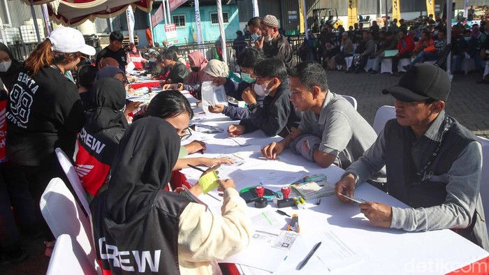 AHM Gelar Mudik Bareng, Motor Bisa Ikut ke Kampung Halaman Sejumlah pekerja menaikan motor pemudik keatas truk yang akan membawanya ke kampung halaman, Jakarta, Senin (17/4/2023).