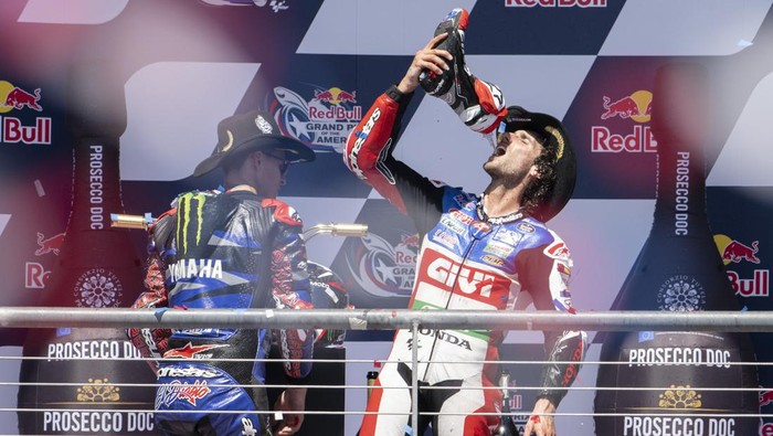 Spains Alex Rins, right, celebrates after his win with Frances Fabio Quartararo, who finished third, after the MotoGP Grand Prix of the Americas motorcycle race at Circuit of the Americas, Sunday, April 16, 2023, in Austin, Texas. (AP Photo/Darren Abate)
