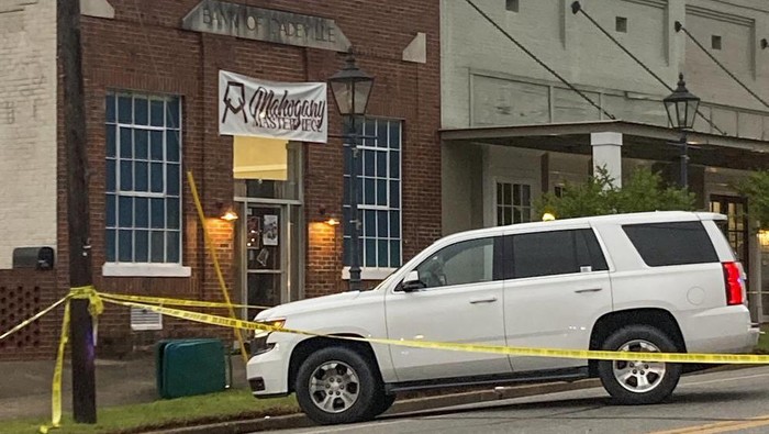 Investigators work at the site of a fatal shooting in downtown Dadeville, Ala., on Sunday, April 16, 2023. Several were killed during a shooting at a birthday party Saturday night, the Alabama Law Enforcement Agency said. (Alex Gladden/The Montgomery Advertiser via AP)