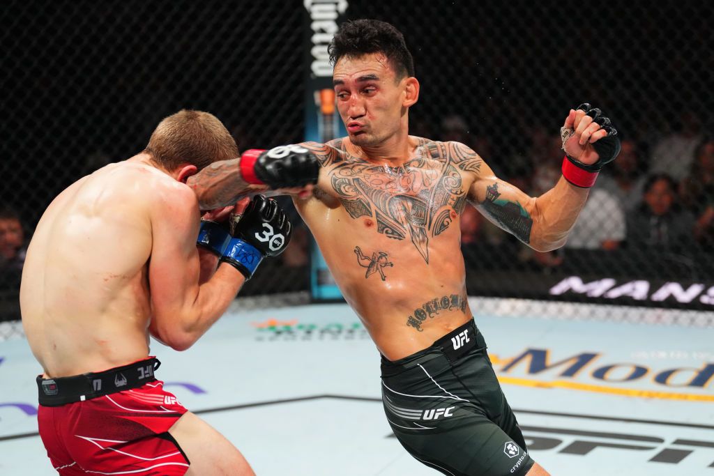 KANSAS CITY, MISSOURI - APRIL 15: (L-R) Max Holloway kicks Arnold Allen of England in a featherweight fight during the UFC Fight Night event at T-Mobile Center on April 15, 2023 in Kansas City, Missouri. (Photo by Josh Hedges/Zuffa LLC via Getty Images)