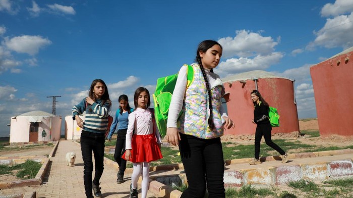 Residents work in an agriculture field near their homes in Jinwar, an all-women village, in Al-Darbasiyah town that controlled by Kurdish-led Syrian Democratic Forces, northeastern Syria, March 7, 2023. REUTERS/Orhan Qereman