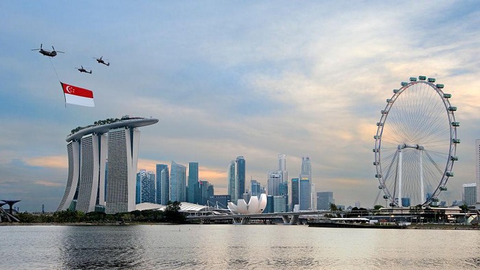 [UNVERIFIED CONTENT] Singapore celebrates its 48th National Day with a flag-bearing Chinook helicopter, escorted by two Apache attack helicopters, flying over Marina Bay.  In the background are Marina Bay Sands on the left and The Singapore Flyer on the right.  This is the full-dress rehearsal for the actual day on 9th Aug.