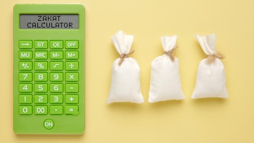 A picture of calculator written Zakat Calculator with 3 rice bags. How to calculate zakat concept.