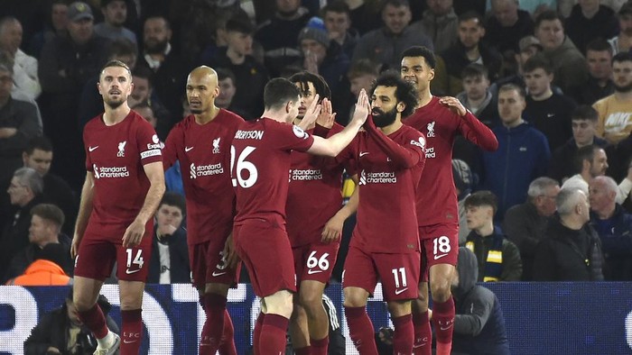 Liverpool players celebrate after Liverpools Mohamed Salah, second right, scored his sides fourth goal during the English Premier League soccer match between Leeds United and Liverpool at Elland Road in Leeds, England, Monday, April 17, 2023. (AP Photo/Rui Vieira)