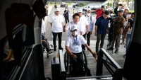 Direktur Utama BSI Hery Gunardi (kiri) membantu salah satu peserta disabilitas menaiki mini bus saat pelepasan BSI Mudik Bareng BUMN di The Tower, Jakarta, Selasa (18/04/2023).