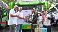 General Manager of CSR SIG, Edy Saraya (kedua kiri) memberikan bingkisan perlengkapan perjalanan kepada Harsono, peserta mudik gratis dari SIG.  