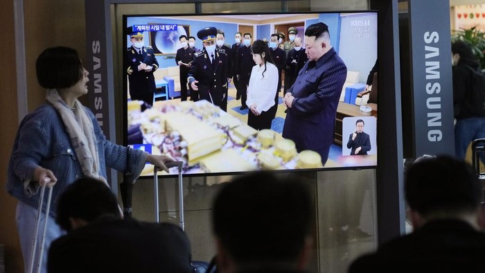 A TV screen shows an image of North Korean leader Kim Jong Un, right, and his daughter during a news program at the Seoul Railway Station in Seoul, South Korea, Wednesday, April 19, 2023. Kim said his country has completed the development of its first military spy satellite and ordered officials to go ahead with its launch as planned, state media reported Wednesday. (AP Photo/Ahn Young-joon)