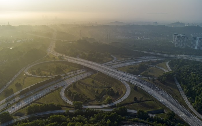 The sun rises over a highway road on the outskirt of Kuala Lumpur, Malaysia, Monday, April 10, 2023. (AP Photo/Vincent Thian)