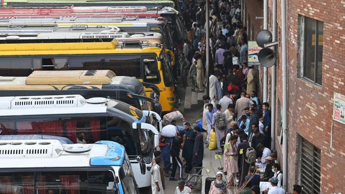 Potret Mudiknya Warga Pakistan, Sampai Naik ke Atap Bus People throng a bus station in Lahore on April 19, 2023, as people head towards their hometowns for the Eid al-Fitr festivities, which marks the end of the holy fasting month of Ramadan. (Photo by Arif Ali / AFP) (Photo by ARIF ALI/AFP via Getty Images)