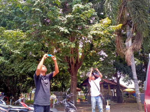 Warga Dompu mengabadikan momen gerhana Matahari Hibrida menggunakan camera ponsel, Kamis (20/4/2023). (Faruk Nickyrawi)